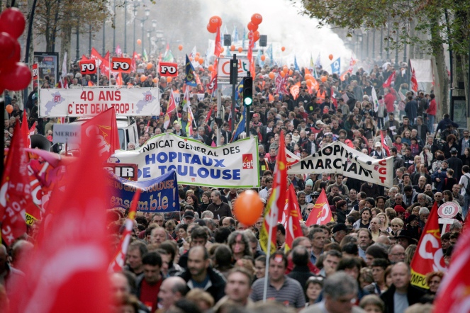 Private and public sector workers take part in a demonstration over pension reforms in Toulouse